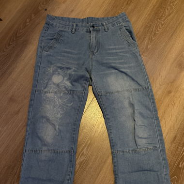 Light blue jeans with white pattern in the front 