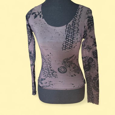 Edgy sheer long sleeve top with full-body print.