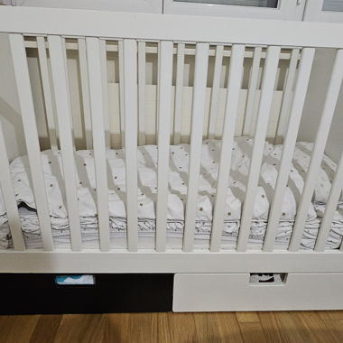 White baby cot with storage drawer