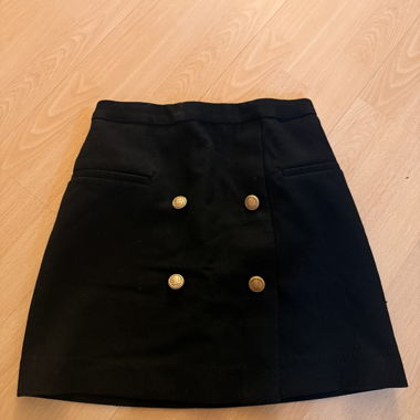 Black mini skirt with gold buttons