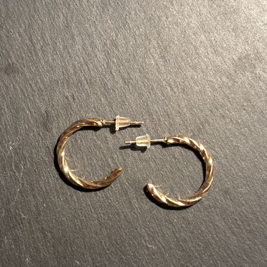 Small gold-colored hoop earrings